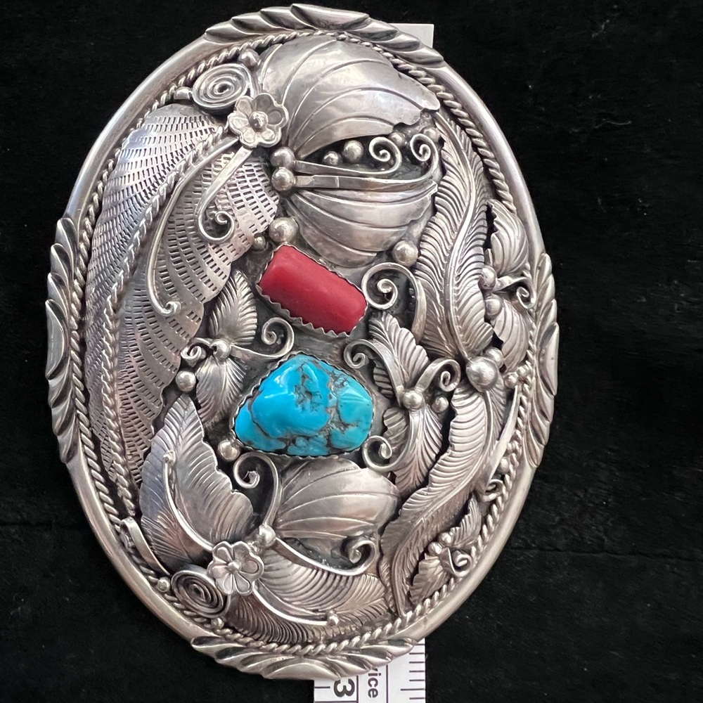 Custom sterling silver belt buckle with corral and turquoise stones.